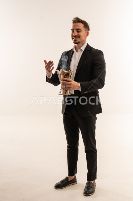 Saudi Man in Black Suit Holding Traditional Incense