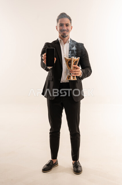 Saudi Man Holding Smartphone and Traditional Incense