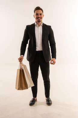 Saudi Man in Suit Holding Shopping Bags on White