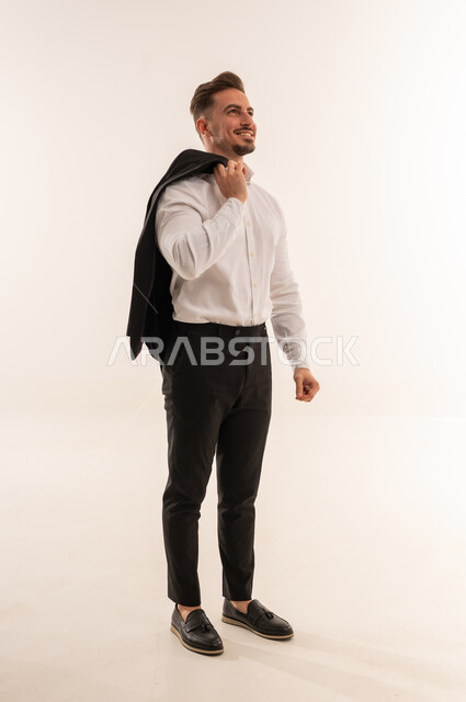 رجل أعمال سعودي يحمل سترة على خلفية بيضاء