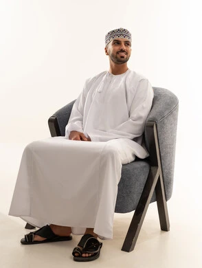 Omani Man in Traditional Dishdasha Sitting in Studio