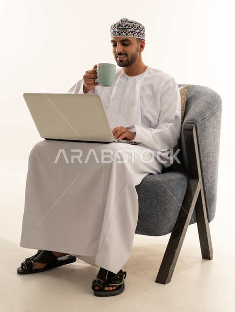 Omani Man Using Laptop in Traditional Dress