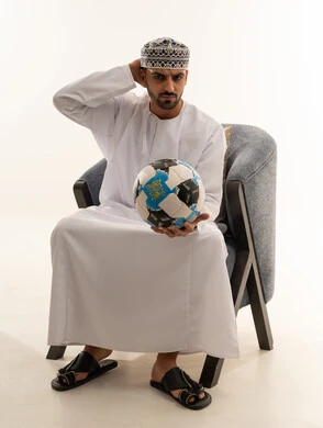 Omani Man in Traditional Dress Holding a Football Studio