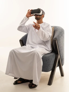 Omani Man Wearing VR Goggles in Traditional Dress