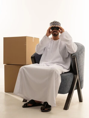 Omani Man with Binoculars and Shipping Boxes