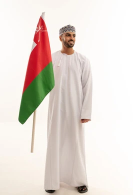 Omani Man in Traditional Dress Holding Oman Flag