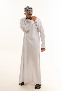 Omani Man in Dishdasha with Shoulder Pain Studio Shot