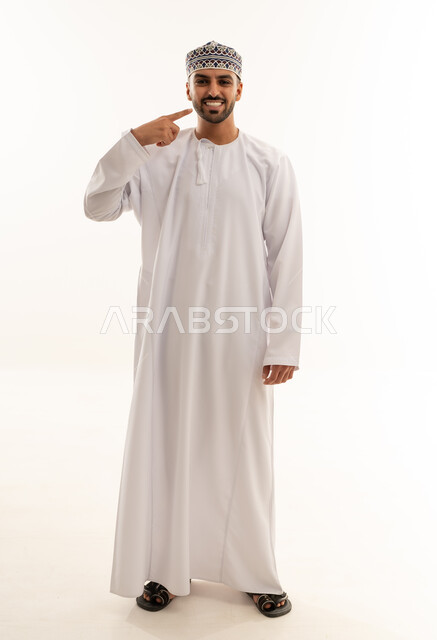 Omani Man in Traditional White Dishdasha and Kumma