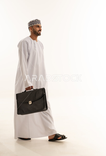 Omani Man in Traditional Dress Walking with Briefcase