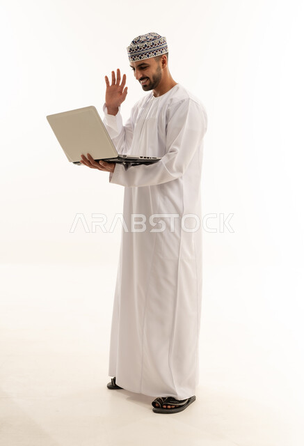 Omani Man in Traditional Dress Using Laptop for Video Call