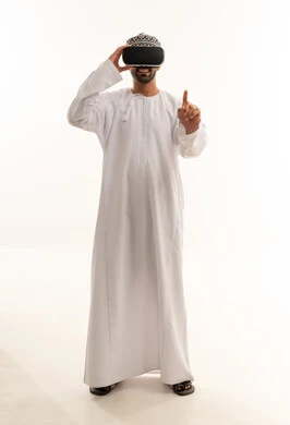 Omani Man Wearing VR Headset in Traditional Dishdasha