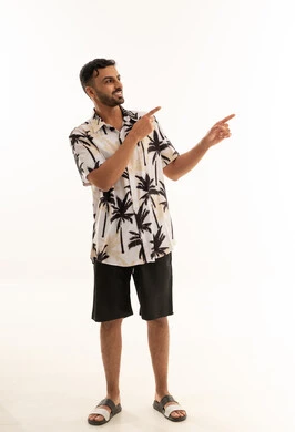 Arab Man in Summer Outfit Pointing on White Background