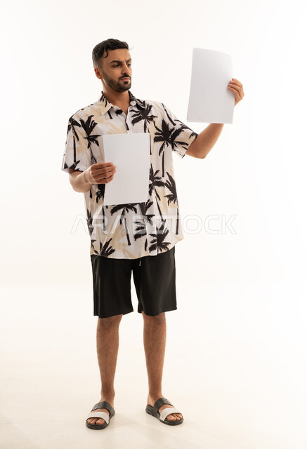 Saudi Man Holding Blank White Papers on White Background