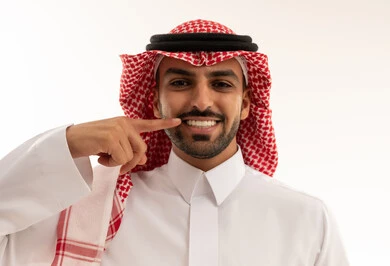 Saudi Man in Traditional Attire Smiling at Teeth