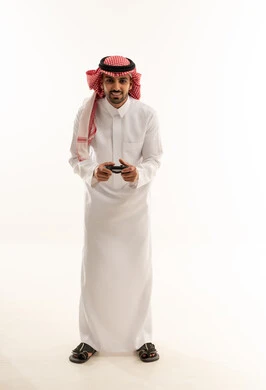 Saudi Man with Video Game Controller in Traditional Thobe