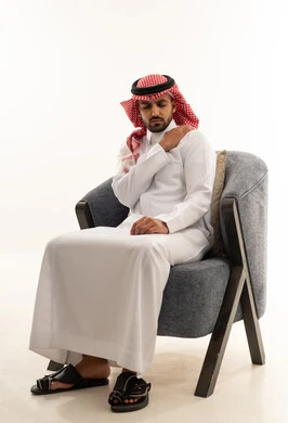 Saudi Man in Traditional Thobe with Shoulder Pain