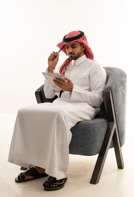 Saudi Man in Traditional Thobe with Clipboard
