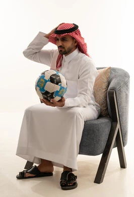 Saudi Man in Thobe Holding Football on White Background