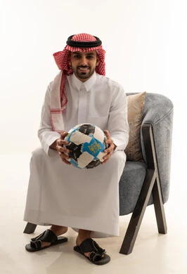 Saudi Man in Traditional Thobe Holding a Soccer Ball