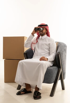 Saudi Man Looking Through Binoculars with Moving Boxes