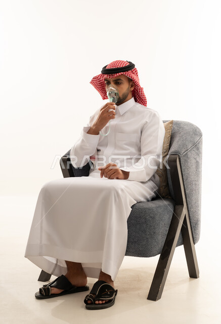 Saudi Man in Thobe Using Nebulizer Treatment