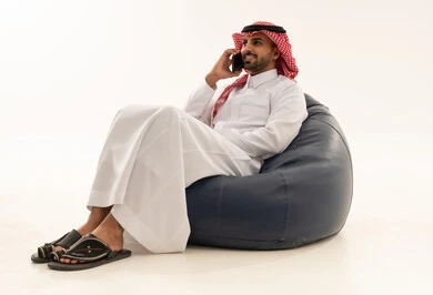 Saudi Man Talking on Smartphone on Beanbag Chair