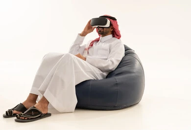 Saudi Man Using Virtual Reality Headset on White Background