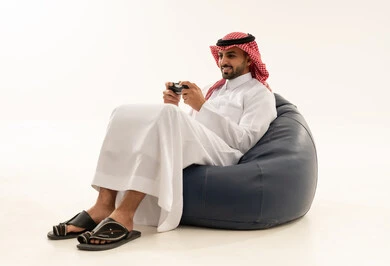 Saudi Man Playing Video Games on Bean Bag