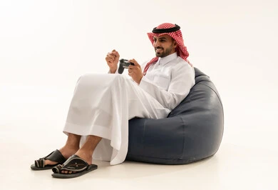 Saudi Man Playing Video Games on Bean Bag