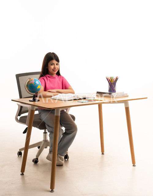 Arab Girl Sitting at Study Desk with Globe and Books