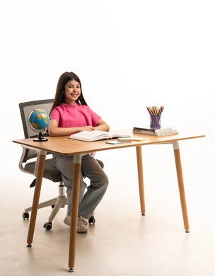 Arab Schoolgirl Studying at Desk on White Background