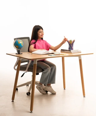 Saudi Girl Studying at Desk with Globe on White Background
