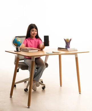 Saudi Girl Holding Smartphone at Wooden Desk