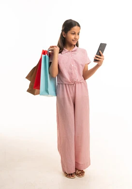 Saudi Girl with Shopping Bags and Smartphone