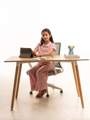 Saudi Girl Using Digital Tablet at Desk for Studying