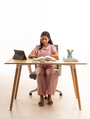Saudi Girl Studying at Wooden Desk with Tablet