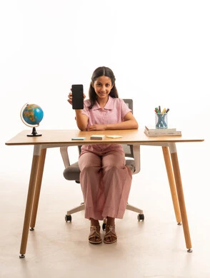 Saudi Girl at Desk Holding Smartphone with Blank Screen