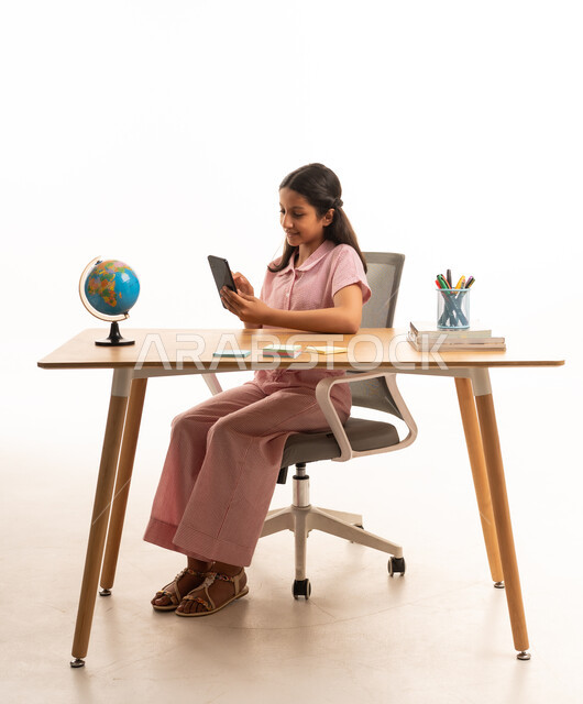 Arab Girl Using Smartphone at Desk on White Background
