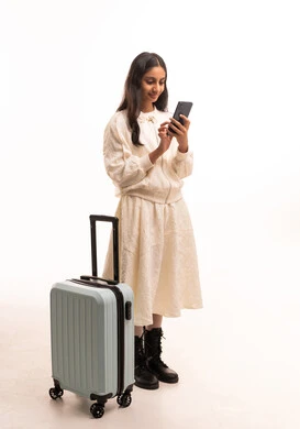 Saudi Girl with Suitcase and Smartphone in Studio
