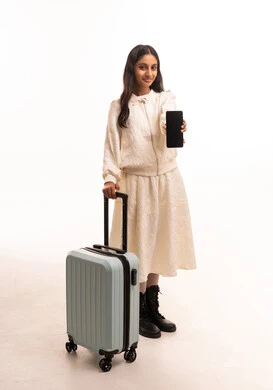 Arab Girl with Suitcase Holding Smartphone in Studio