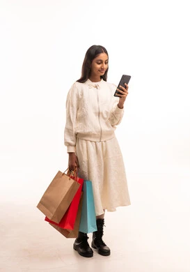 Indian Girl with Shopping Bags and Smartphone Indian Girl with Shopping Bags and Smartphone