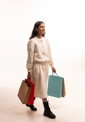 Young Saudi Woman Walking with Shopping Bags in Studio
