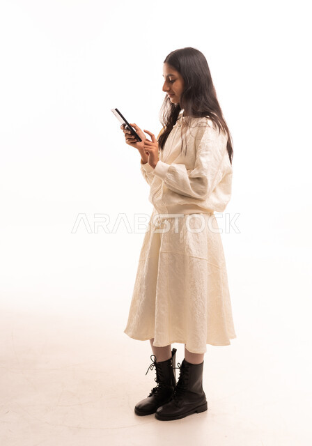 Arab Girl Using Smartphone in Studio Setting