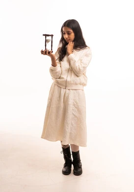 Young South Asian Woman Holding Hourglass in Studio Young South Asian Woman Holding Hourglass in Studio