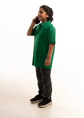 Arab Boy Talking on Smartphone in Green Polo Shirt