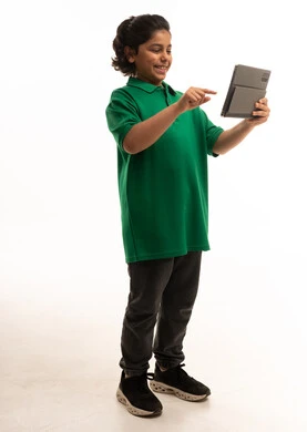 طفل سعودي يستخدم جهاز لوحي على خلفية بيضاء