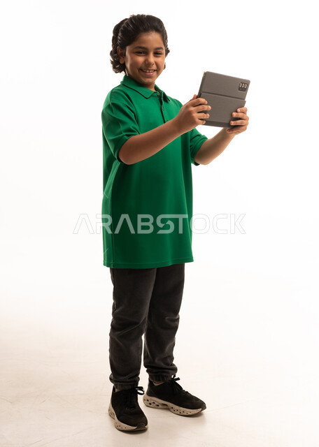 Saudi Boy Holding Tablet on White Background