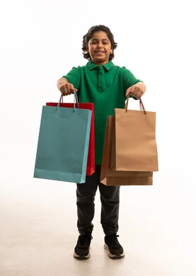 Arab Boy Holding Shopping Bags on White Background