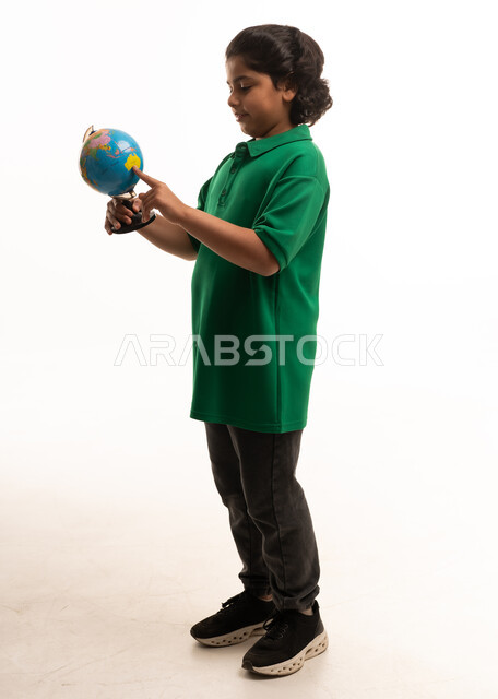 Arab Boy Student Pointing at Globe on White Background