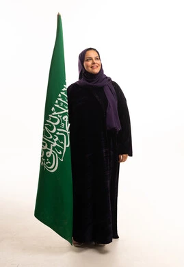 Saudi Woman in Black Abaya with National Flag